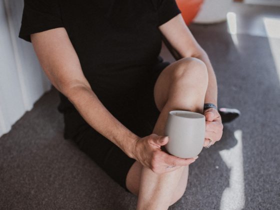 Woman sitting cross legged holding mug